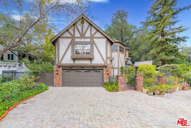 tudor-style house with a garage