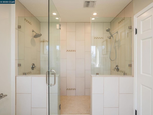 bathroom with a shower with door