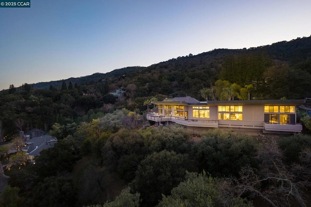 back house at dusk featuring a mountain view