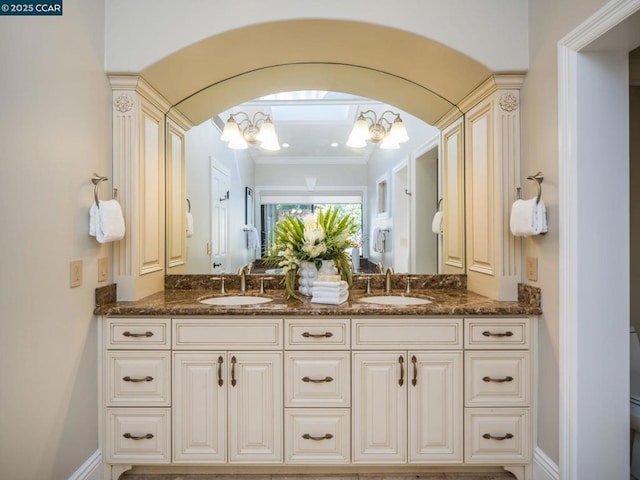 bathroom with vanity, toilet, and a chandelier