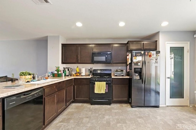 kitchen featuring sink, dark brown cabinets, black appliances, and kitchen peninsula