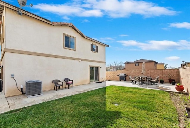 rear view of house featuring a yard, central AC unit, and a patio area