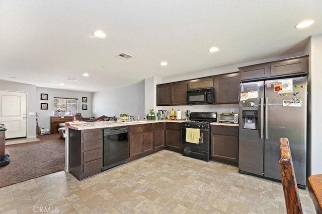 kitchen featuring sink, dark brown cabinets, black appliances, light carpet, and kitchen peninsula