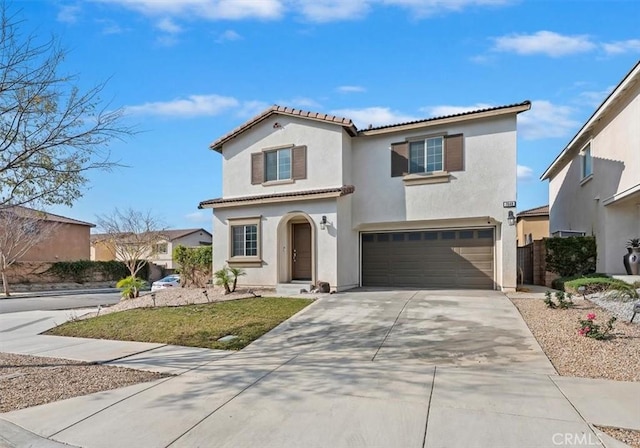 mediterranean / spanish house with a garage