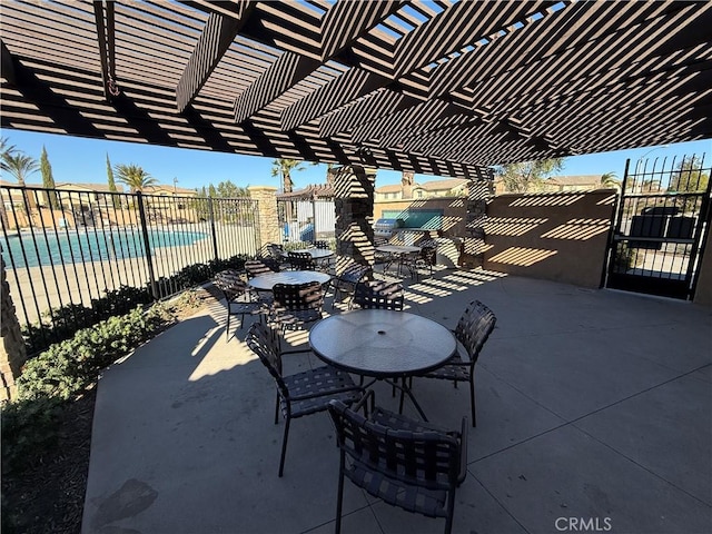 view of patio / terrace with a community pool and a pergola