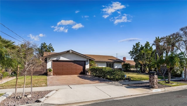 view of front of property featuring a front yard and a garage