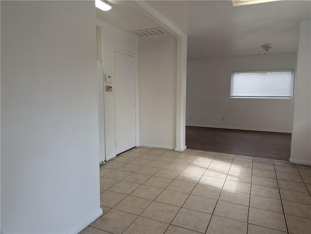 spare room featuring light tile patterned flooring