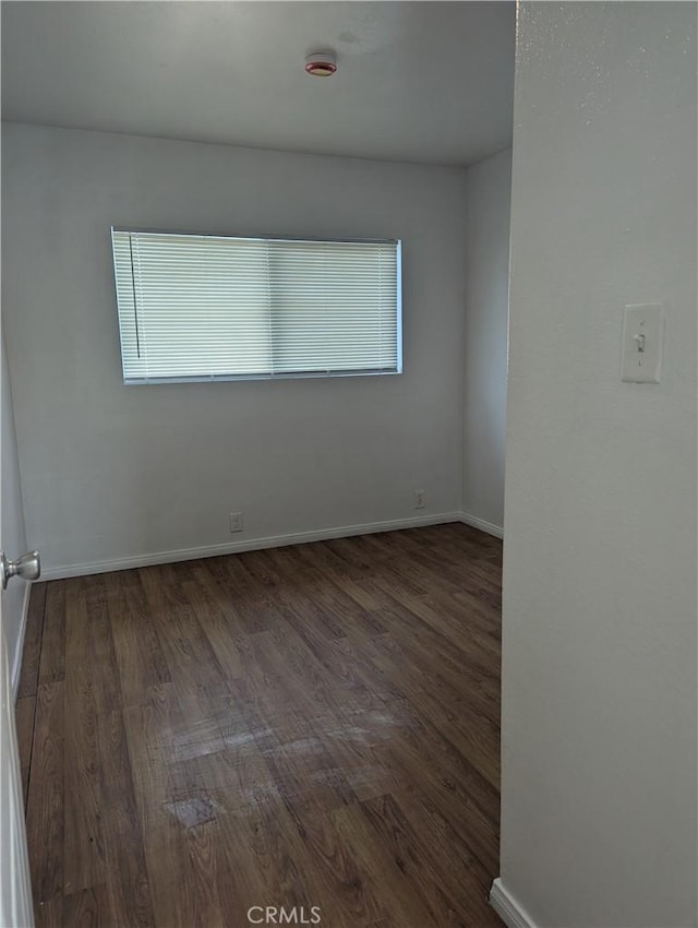 spare room with dark wood-type flooring