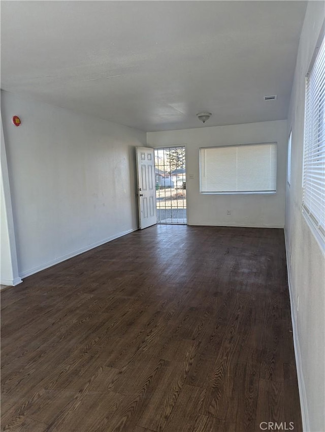 unfurnished room with dark hardwood / wood-style floors