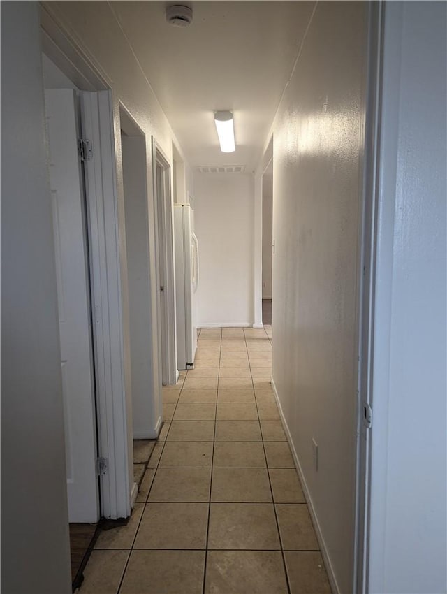 corridor featuring light tile patterned floors