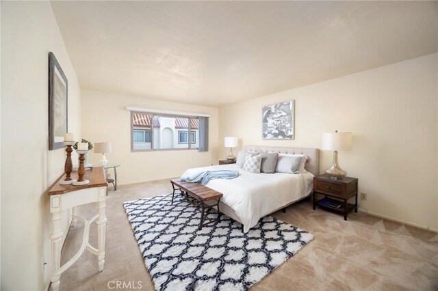 bedroom featuring light carpet