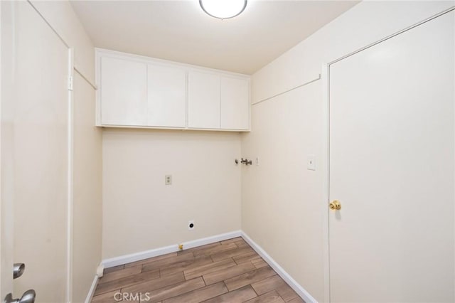 laundry room featuring hookup for a washing machine, cabinets, and hookup for an electric dryer