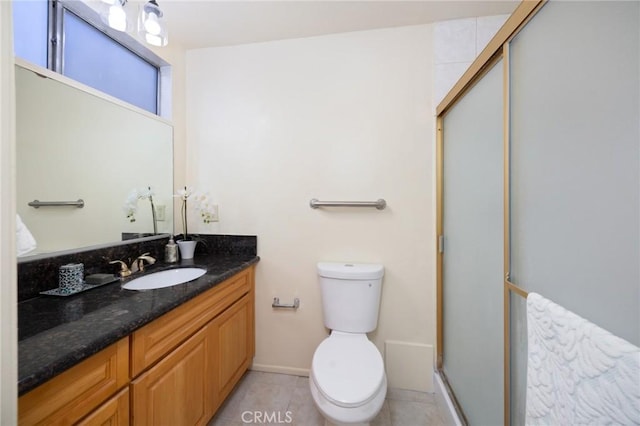 bathroom with toilet, a shower with door, tile patterned floors, and vanity