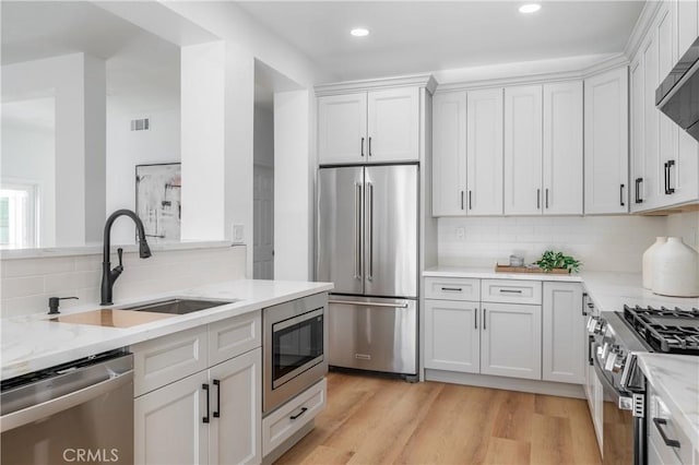 kitchen featuring sink, white cabinets, and appliances with stainless steel finishes