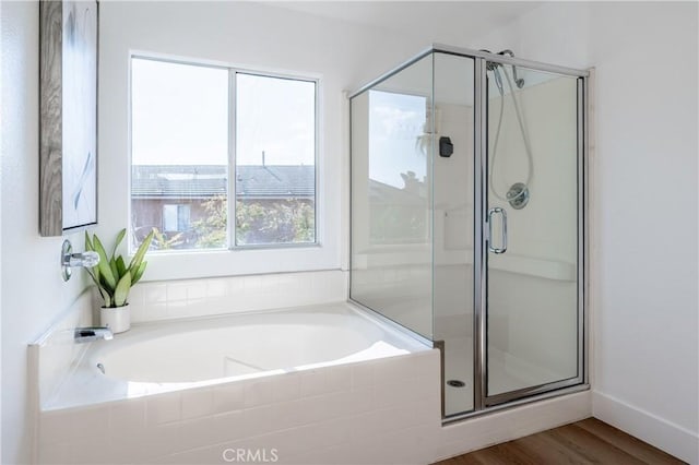 bathroom featuring hardwood / wood-style flooring and separate shower and tub