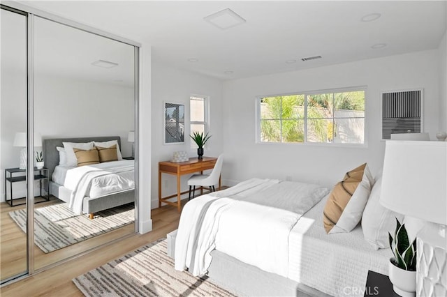 bedroom featuring light hardwood / wood-style floors and a closet