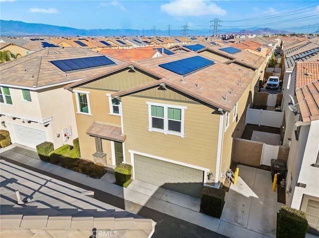 13946 Blossom Way, Eastvale, CA 92880 - view of front of property featuring an attached garage, roof mounted solar panels, and a residential view