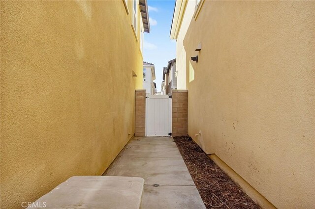 13946 Blossom Way, Eastvale, CA 92880 - view of property exterior featuring stucco siding and a gate