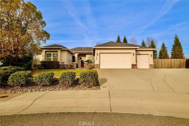 3600 Laver Ct, Redding, CA 96002 - view of front of home with stucco siding, driveway, a garage, and stone siding