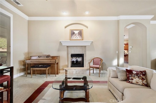 3600 Laver Ct, Redding, CA 96002 - living area with crown molding, arched walkways, a tiled fireplace, carpet floors, and baseboards