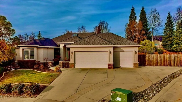3600 Laver Ct, Redding, CA 96002 - ranch-style home featuring concrete driveway, an attached garage, fence, stucco siding, and stone siding