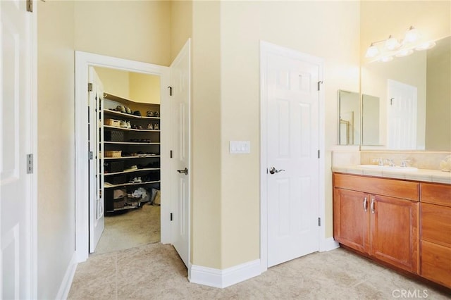 3600 Laver Ct, Redding, CA 96002 - full bath with vanity, a walk in closet, and baseboards