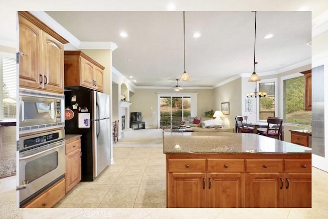 3600 Laver Ct, Redding, CA 96002 - kitchen with appliances with stainless steel finishes, ornamental molding, a fireplace, light stone countertops, and light tile patterned flooring