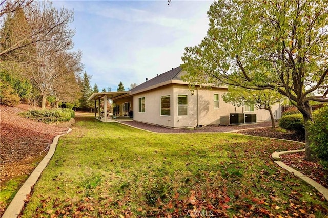 3600 Laver Ct, Redding, CA 96002 - back of house with a lawn, cooling unit, and stucco siding