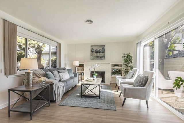 living room with hardwood / wood-style flooring and a fireplace