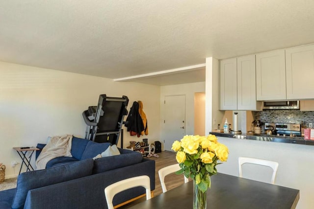 dining room with hardwood / wood-style flooring and a textured ceiling