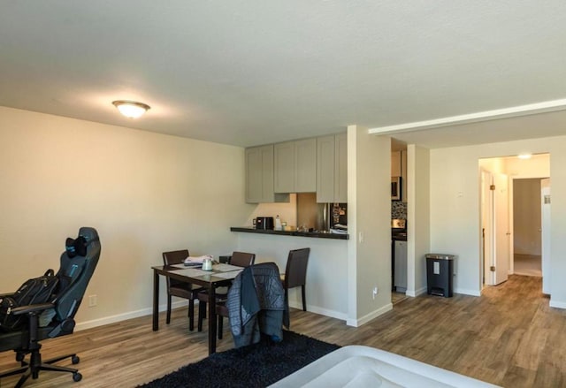 dining space with wood-type flooring