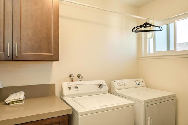 laundry room featuring cabinets and washer and dryer