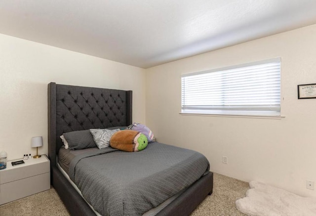 bedroom featuring light colored carpet