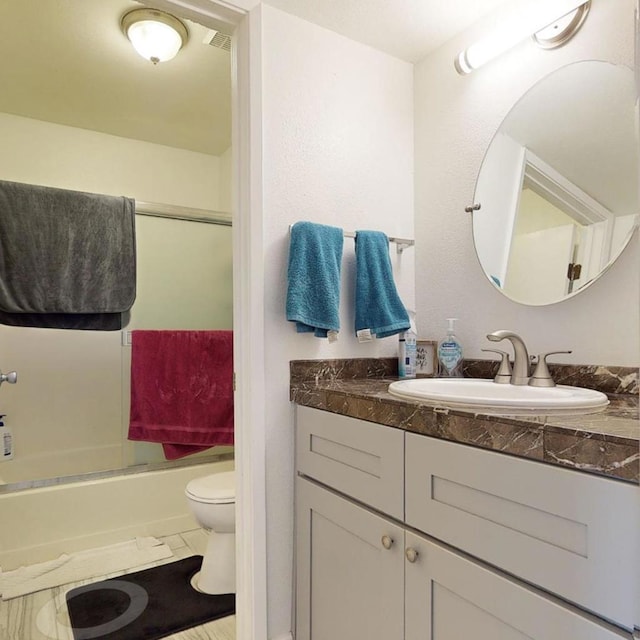 full bathroom with vanity, tile patterned floors, toilet, and combined bath / shower with glass door