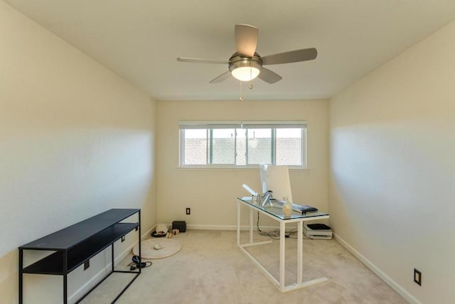 carpeted office space featuring ceiling fan