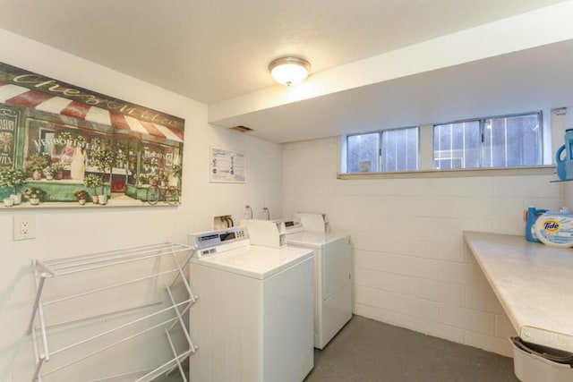 clothes washing area featuring independent washer and dryer