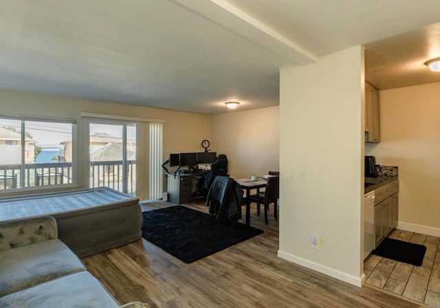 living room with beam ceiling and light hardwood / wood-style floors