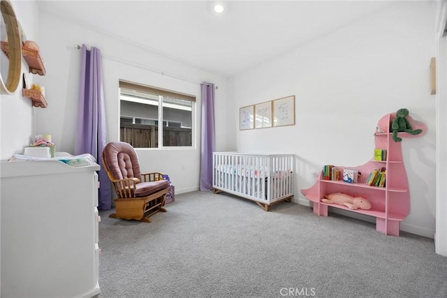 carpeted bedroom with a nursery area