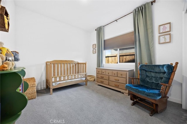 carpeted bedroom featuring a crib