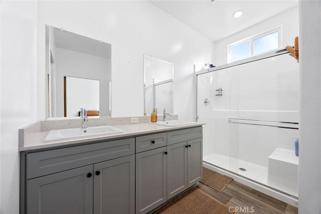 bathroom featuring vanity, a shower with door, and hardwood / wood-style flooring