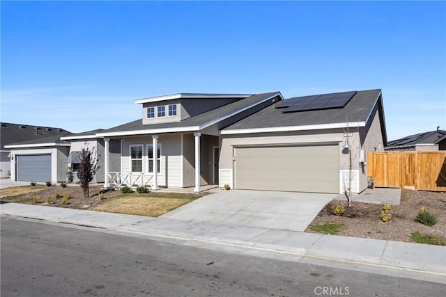 view of front of home featuring a garage and solar panels