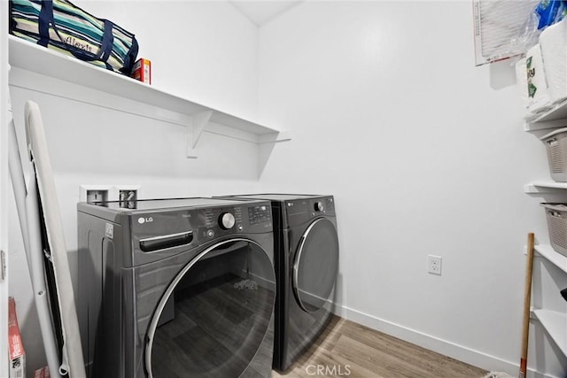 washroom featuring hardwood / wood-style floors and independent washer and dryer