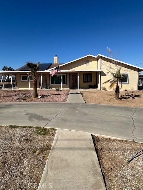 ranch-style home with solar panels