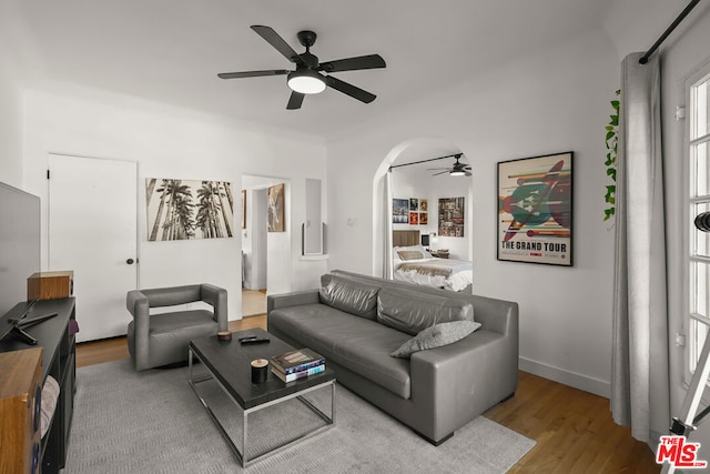 living room with ceiling fan and light hardwood / wood-style floors