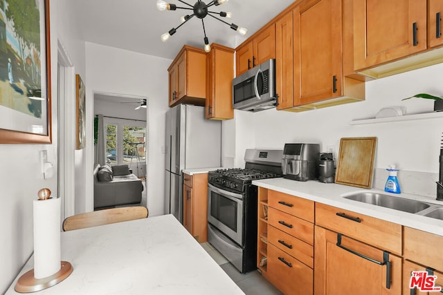 kitchen featuring ceiling fan, sink, and stainless steel appliances