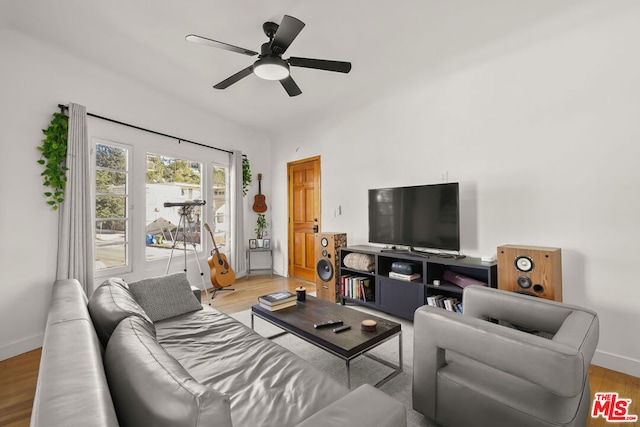 living room featuring ceiling fan and light hardwood / wood-style flooring