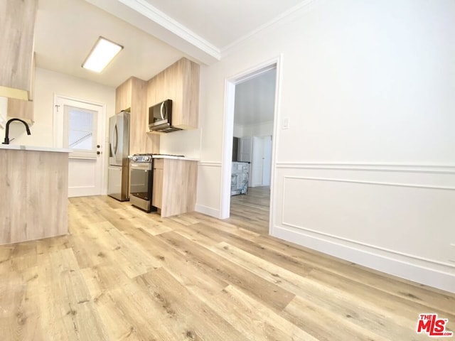 kitchen with appliances with stainless steel finishes, light brown cabinets, light wood-type flooring, crown molding, and sink