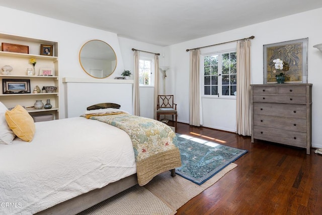 bedroom with dark hardwood / wood-style floors