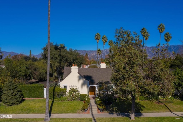 exterior space with a mountain view and a lawn