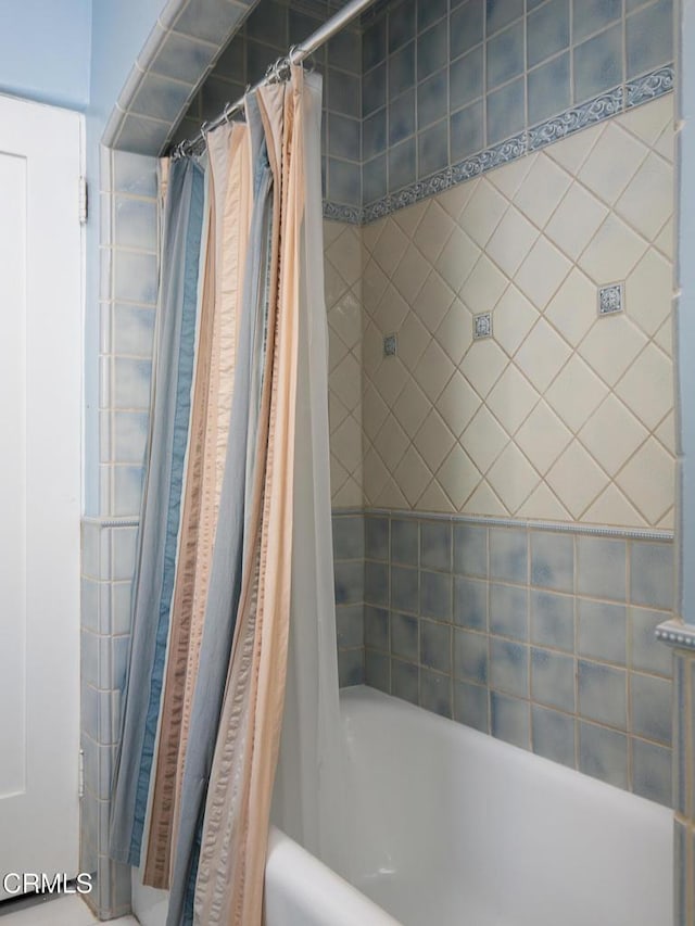 bathroom featuring shower / bath combination with curtain